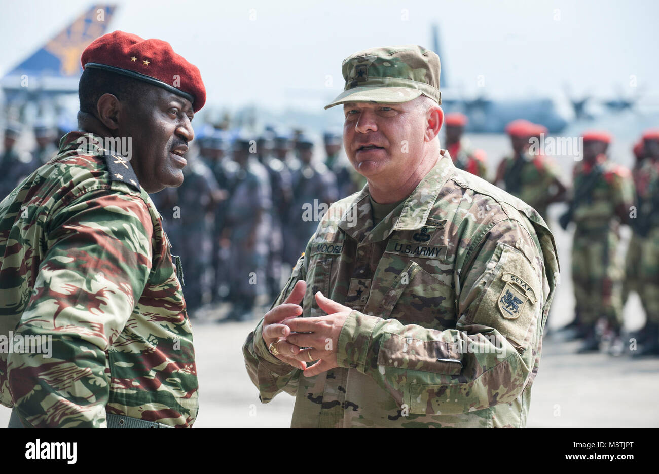 U.S. Army Brig. Gen. Kenneth Moore Jr. (right), Deputy Commander U.S. Army Africa, and Brig. Gen. Ferdinand Gaspard Olame Ndong (left), Deputy Chief of the General Staff of the Gabonese Armed Forces, speak with one another during the opening day ceremony for this year’s Central Accord Exercise in Libreville, Gabon on June 13, 2016. U.S. Army Africa’s exercise Central Accord 2016 is an annual, combined, joint military exercise that brings together partner nations to practice and demonstrate proficiency in conducting peacekeeping operations. (DoD News photo by TSgt Brian Kimball) 160613-F-QP401- Stock Photo