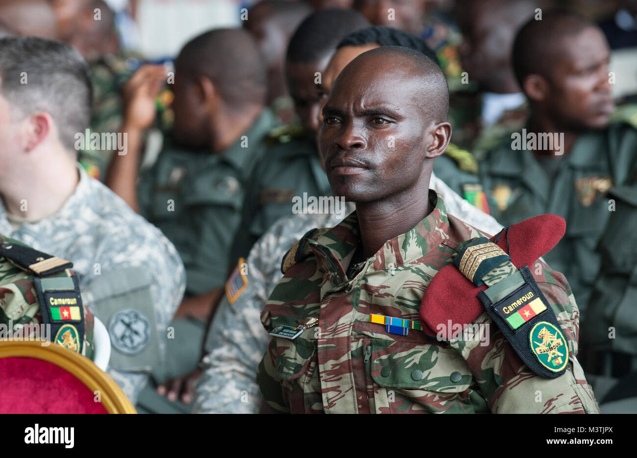 A Member Of The Cameroonian Armed Forces Listens To A Guest Speaker a-member-of-the-cameroonian-armed-forces-listens-to-a-guest-speaker