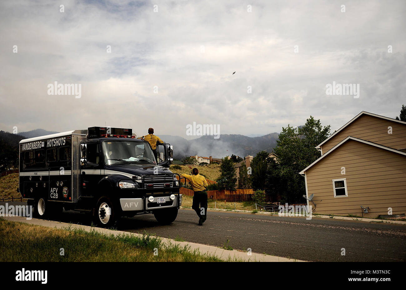 Vandenberg Hot Shot Richard Strange, left, and Marissa Halbeisen look out at their worksite for the day in the Mount St. Francis area of Colorado Springs, Co. The team cut a fire line while helping to battle several fires in Waldo Canyon. The Waldo Canyon fire had grown to 18,500 acres and burned more than 300 homes. At the time, more than 90 firefighters from the Air Force Academy, along with assets from Air Force Space Command; F.E. Warren Air Force Base, Wyo.; Fort Carson, Colo.; and the local community continued to fight the Waldo Canyon fire. (U.S. Air Force photo by Master Sgt. Jeremy Lo Stock Photo