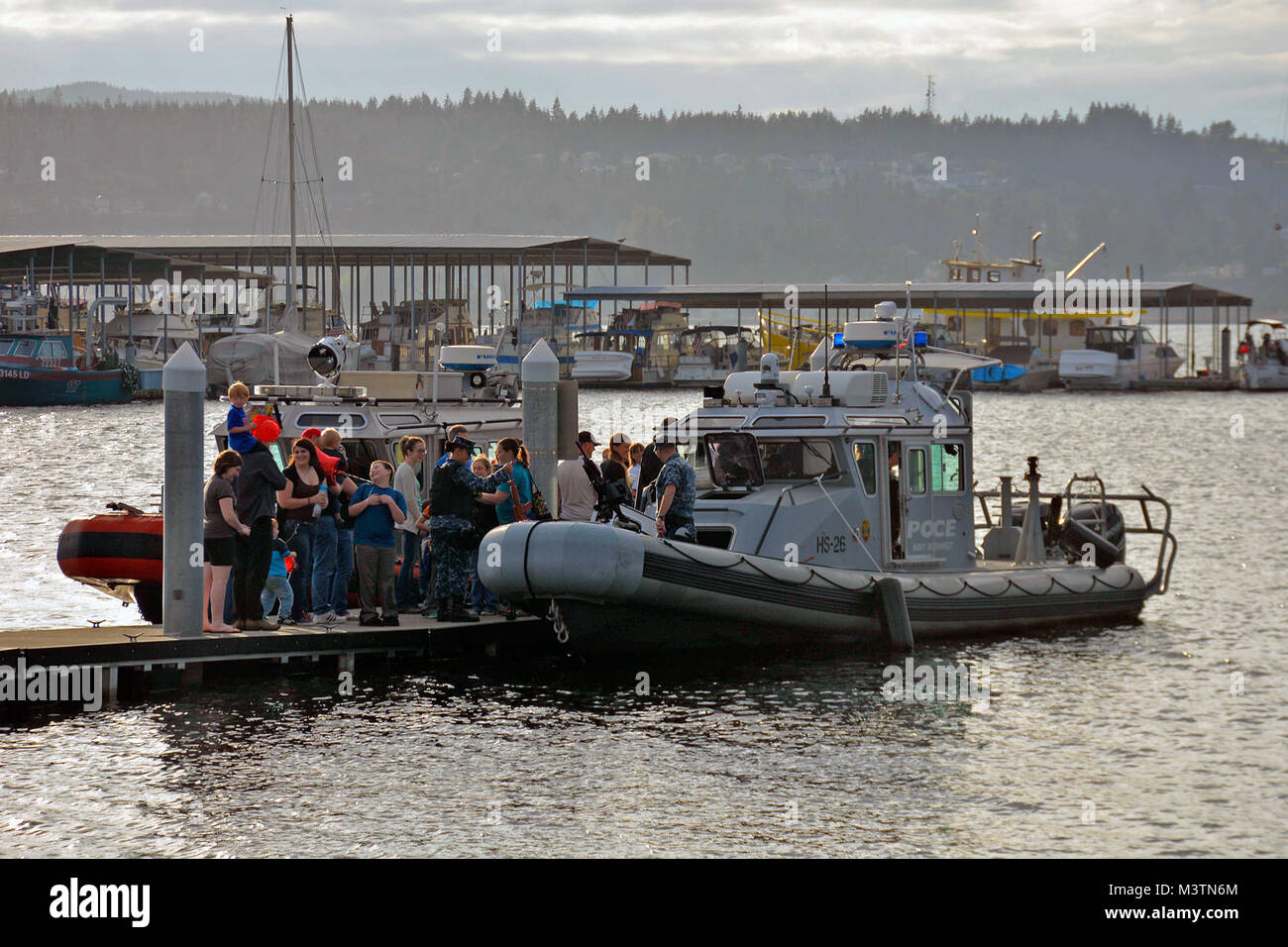 160802-N-SP496-009 PORT ORCHARD, Wash. (Aug. 2, 2016) – Members of the Navy Region Northwest (NRNW), Harbor Security, Naval Base Kitsap (NBK), mingle with local residents during National Night Out in Port Orchard, Wash. National Night Out is a combined effort to promote involvement in crime prevention activities, police-community partnerships and neighborhood camaraderie. (U.S. Navy photo by Airman Jane Wood) 160802-N-SP496-009 by Naval Base Kitsap (NBK) Stock Photo