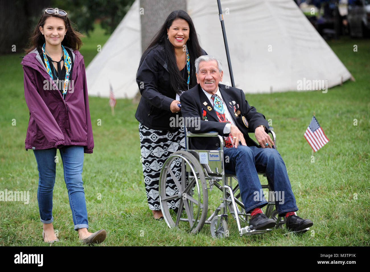 World War II /Korean War Native American Veteran and first wave D-Day survivor, Mr. Norman Shay (foreground), is escorted by Chicago Sympathy Orchestra National Anthem singer, Beena Davis, prior to breakfast during the 2nd Annual National Gathering of American Indian Veterans.  The event was held at Cantigny Park located in Wheaton, Illinois 19-21 August 2016.  The event celebrated the long and proud history of Native Americans’ service to the United States Military and honors all veterans American Indian style.   (DoD photo by Marvin Lynchard) 160821-D-FW736-001 by DoD News Photos Stock Photo