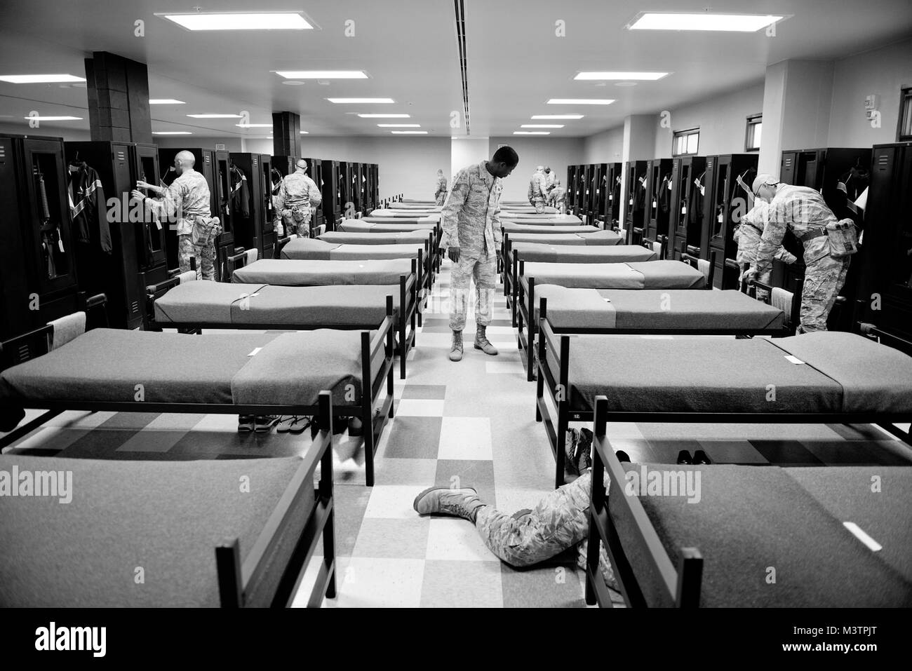 323rd Training Squadron, military training instructor, Tech. Sgt. Chananyah Stuart, inspects his flight's dorm after an earlier surprise inspection produced several discrepancies at Joint Base San Antonio-Lackland, Texas. Flight 552 is in their final week of training and Stuart uses the inspections to fight complacency amongst the trainees. (U.S. Air Force photo by Master Sgt. Jeffrey Allen) 140923-F-CP197-611 by AirmanMagazine Stock Photo