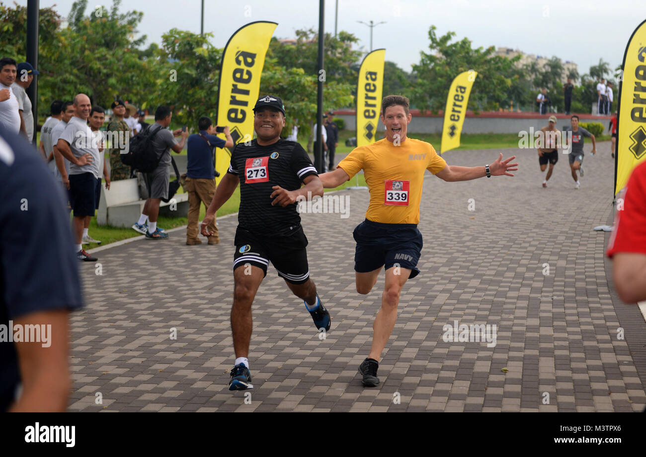 PANAMA CITY, Panama (Sept. 20, 2016) - Chief Boatswain's Mate Justin Noelke, a Sailor assigned to USNS Spearhead (T-EPF-1), encourages a Mexican UNITAS partner nation member during a fun run at the Estadio Maracaná de Panamá soccer stadium. UNITAS is an annual multi-national exercise that focuses on strengthening our existing regional partnerships and encourages establishing new relationships through the exchange of maritime mission-focused knowledge and expertise throughout the exercise. (U.S. Navy Photo by Mass Communication Specialist 1st Class Jacob Sippel/RELEASED) 160920-N-AW702-003 by U Stock Photo