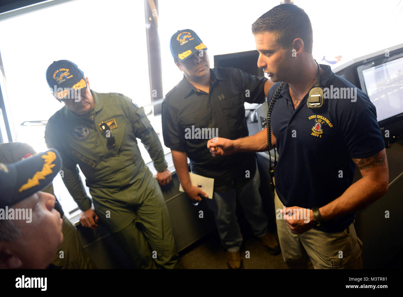 GULF OF PANAMA (Sept. 24, 2016) - USNS Spearhead (T-EPF 1) Chief Mate Adam Steeper gives a tour of the ship to Belsio González Director General Servicio Nacional Aeronaval, Alexis Bethancourt Yau, Panama Minister of Security and other guests during UNITAS 2016. UNITAS is an annual multi-national exercise that focuses on strengthening our existing regional partnerships and encourages establishing new relationships through the exchange of maritime mission-focused knowledge and expertise throughout the exercise. (U.S. Navy Photo by Mass Communication Specialist 1st Class Jacob Sippel/RELEASED) 16 Stock Photo