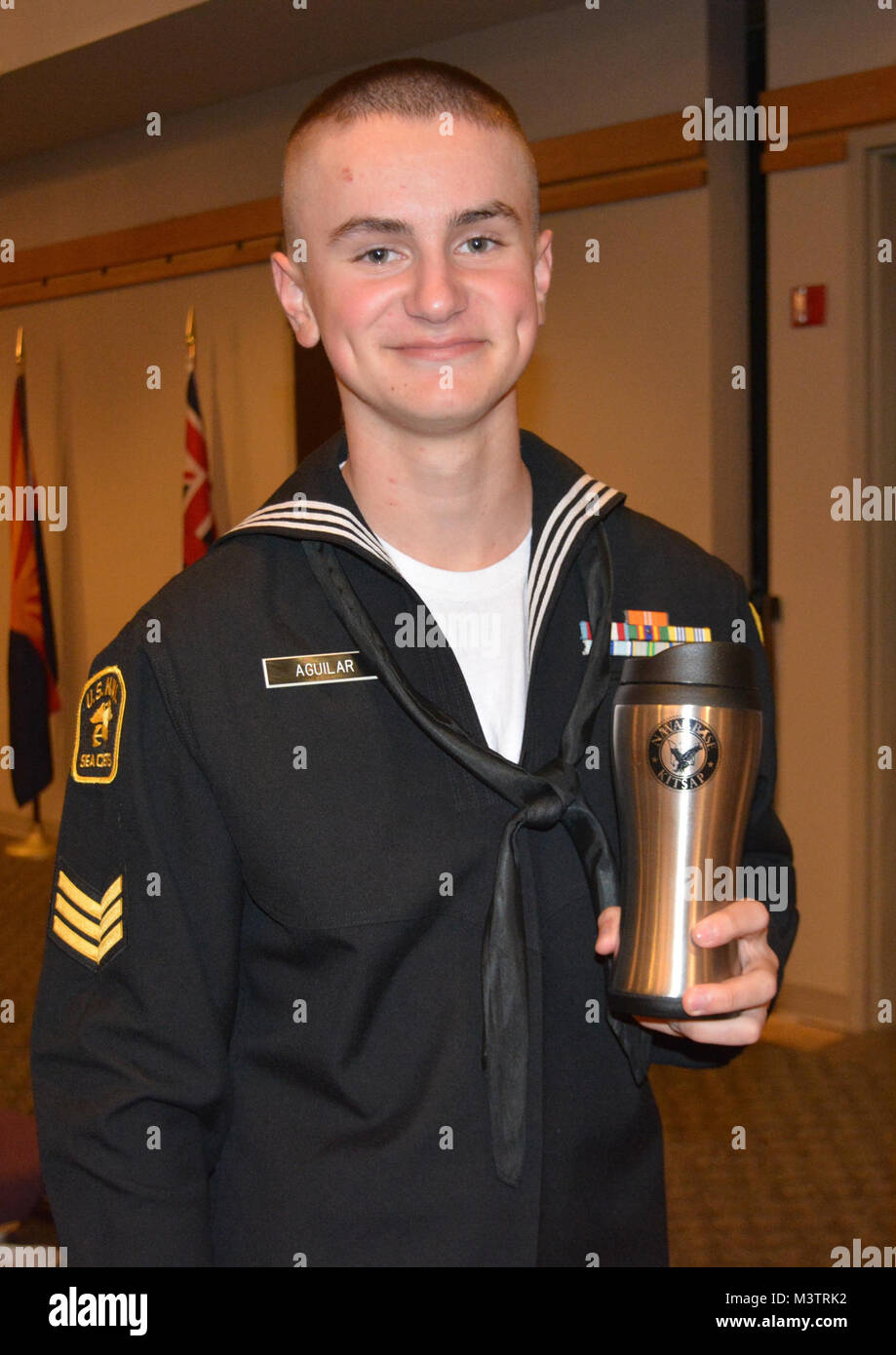 161008-N-VM861-017 BANGOR, Wash. (Oct. 8, 2016) – U.S. Naval Sea Cadet Corps Petty Officer 3rd Class Thomas Aguilar shows the Naval Base Kitsap(NBK) travel coffee cup he won from a raffle at the 2016 Navy Ball, held in the Bangor Ball Room, Naval Base Kitsap (NBK) – Bangor. The Navy Ball is an annual event, which celebrates the heritage, history and the day Congress created the U.S. Navy, Oct. 13, 1775. The Navy has a 241-year heritage of defending freedom and projecting and protecting U.S. interests around the globe. (U.S. Navy photo by Petty Officer 3rd Class Jessica Maue) 161008-N-VM861-017 Stock Photo