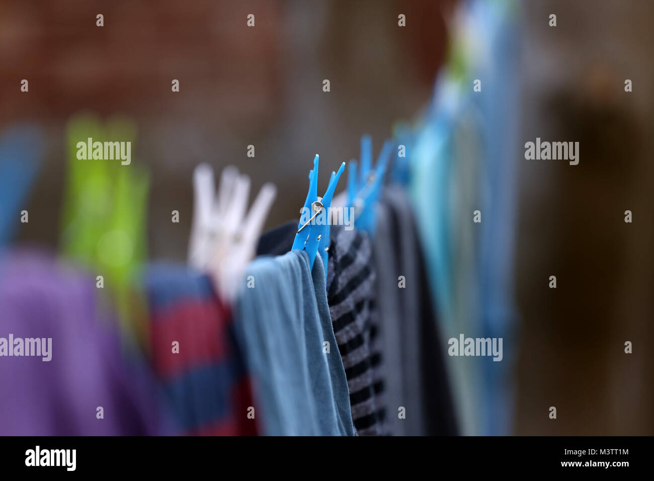 Clothes pegs holding washing on a clothes line, in Peterborough