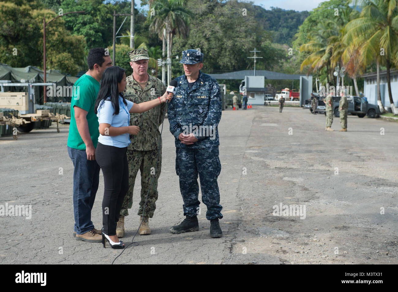 170201-N-YL073-001 (Feb. 1, 2017) PUERTO BARRIOS - Capt. Errin Armstrong, Mission Commander for Continuing Promise 2017 (CP-17), and Lt. Cmdr. Robert Lennon, CP-17's medical officer-in-charge, speak with a local cable news reporter in Puerto Barrios, Guatemala, during a CP-17 media event. CP-17 is a U.S. Southern Command-sponsored and U.S. Naval Forces Southern Command/U.S. 4th Fleet-conducted deployment to conduct civil-military operations including humanitarian assistance, training engagements, and medical, dental, and veterinary support in an effort to show U.S. support and commitment to Ce Stock Photo