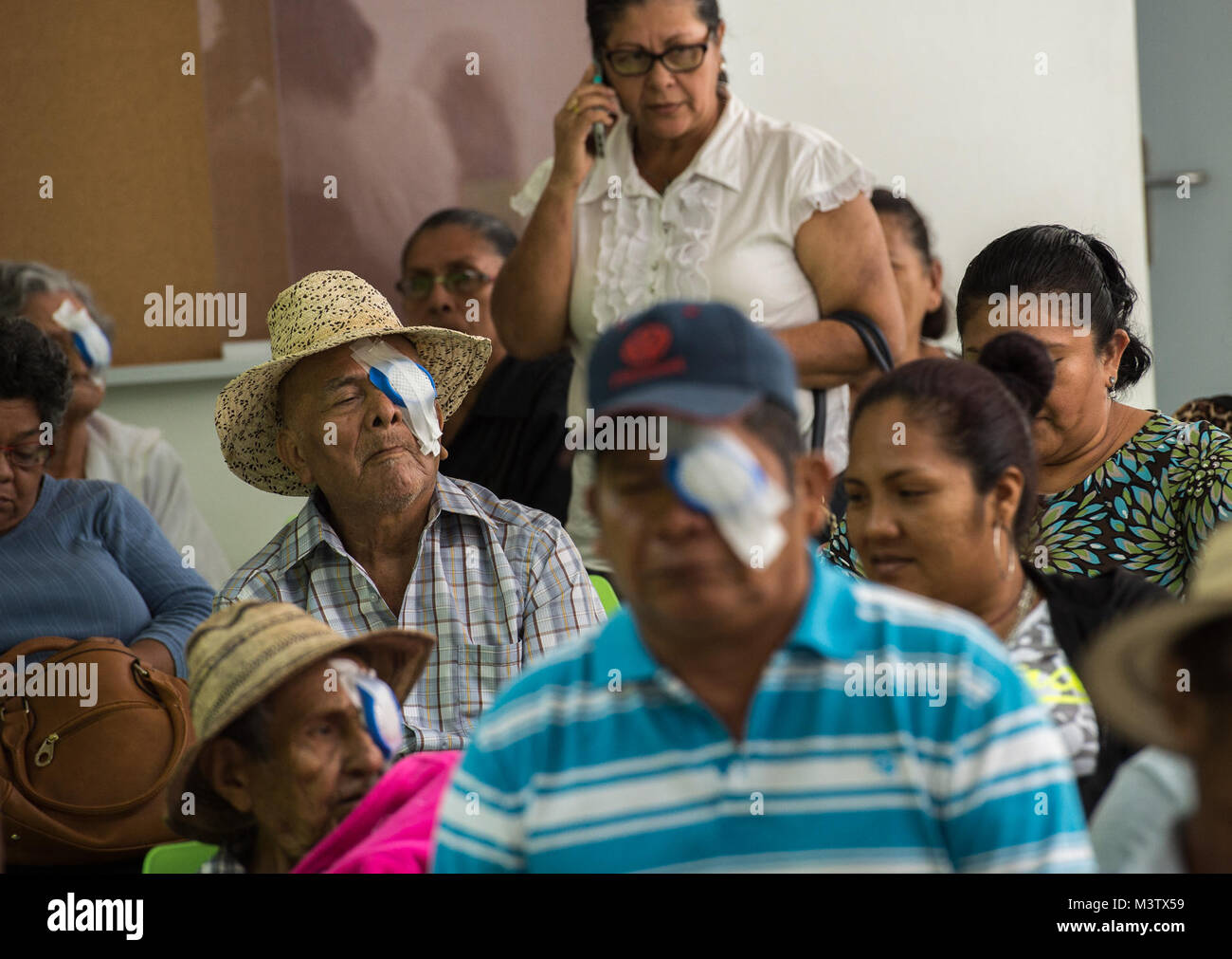 Eye surgery patients wait for their follow-up appointments, Feb. 6, 2017, after getting cataract surgery at the Centro Hospitalario Luis 'Chicho' Fabrega, Santiago, Panama, during a medical readiness training exercise. A U.S. military medical team was in Panama to help treat individuals with cataracts that otherwise would have gone untreated. Medical readiness training exercises provide U.S. military personnel training in delivery of medical care in austere conditions, promote diplomatic relations between the U.S. and host nations in Central America and provide humanitarian and civic assistanc Stock Photo