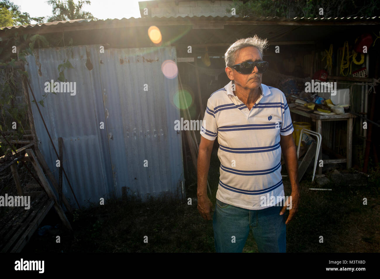 Eduardo Barrera stands in front of his work shed, Feb. 7, 2017, after having an extracapsular cataract extraction with intraocular implant surgery the day before at the Centro Hospitalario Luis 'Chicho' Fabrega during a medical readiness training exercise in Santiago, Panama. A U.S. military medical team was in Panama to help treat individuals with cataracts that otherwise would have gone untreated. Medical readiness training exercises provide U.S. military personnel training in delivery of medical care in austere conditions, promote diplomatic relations between the U.S. and host nations in Ce Stock Photo