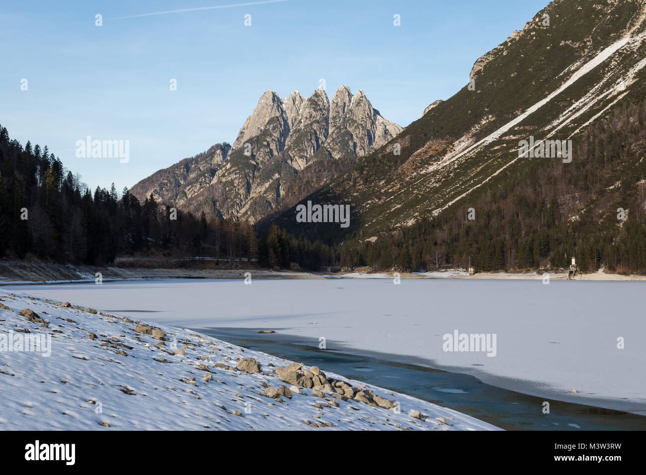 Lago del Predil (Predil Lake) in winter with the Cinque Punte mountain in the background, Friuli Venezia Giulia, Italy Stock Photo