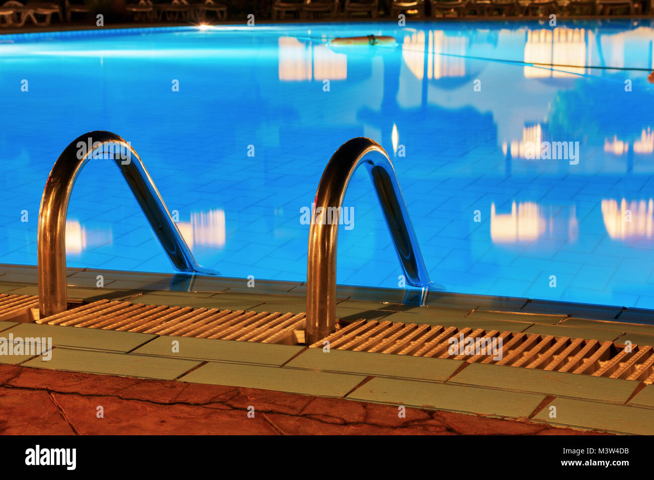 Blue water and handrails to enter the water Stock Photo - Alamy