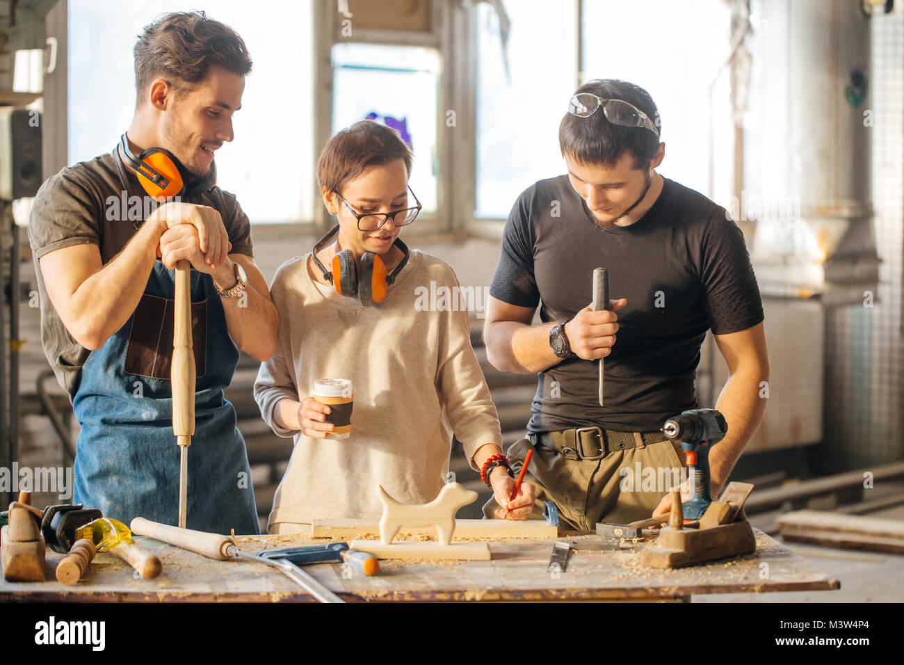 Carpenter Training Female Apprentice To Use Plane Stock Photo Alamy