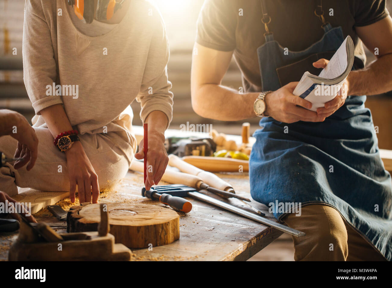 Carpenter Training Female Apprentice To Use Plane Stock Photo Alamy