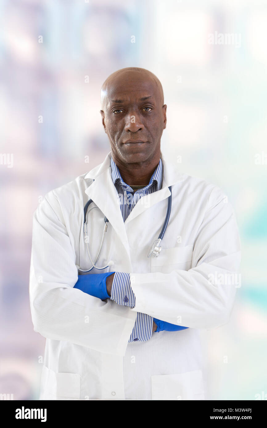 Portrait of an handsome serious smiling doctor on white background ...