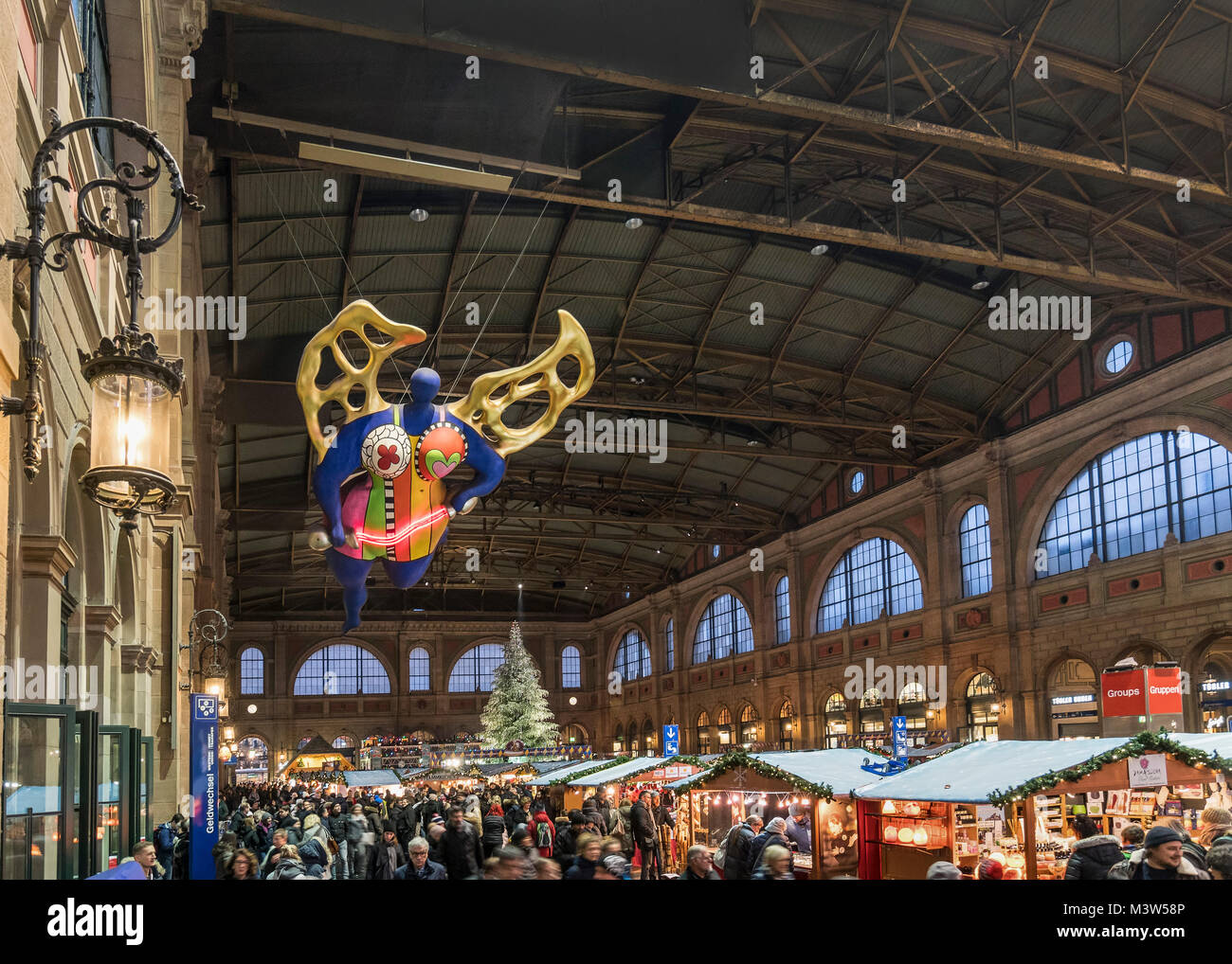 Christmas market Zurich main station, guardian angel by Niki de St. Phalle, Zurich, Switzerland Stock Photo