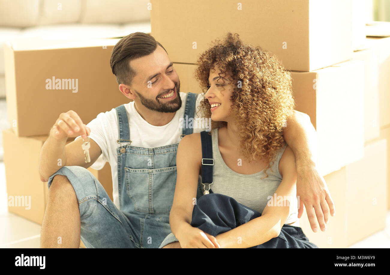 smiling couple on the background of large cardboard boxes Stock Photo ...