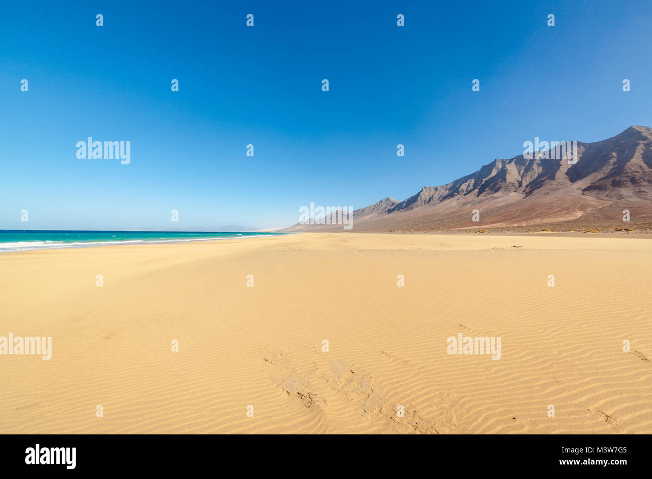 Cofete beach, Fuerteventura, Canary Islands, Spain. Amazing Cofete beach with endless horizon. Volcanic hills in the background and Atlantic Ocean. Stock Photo