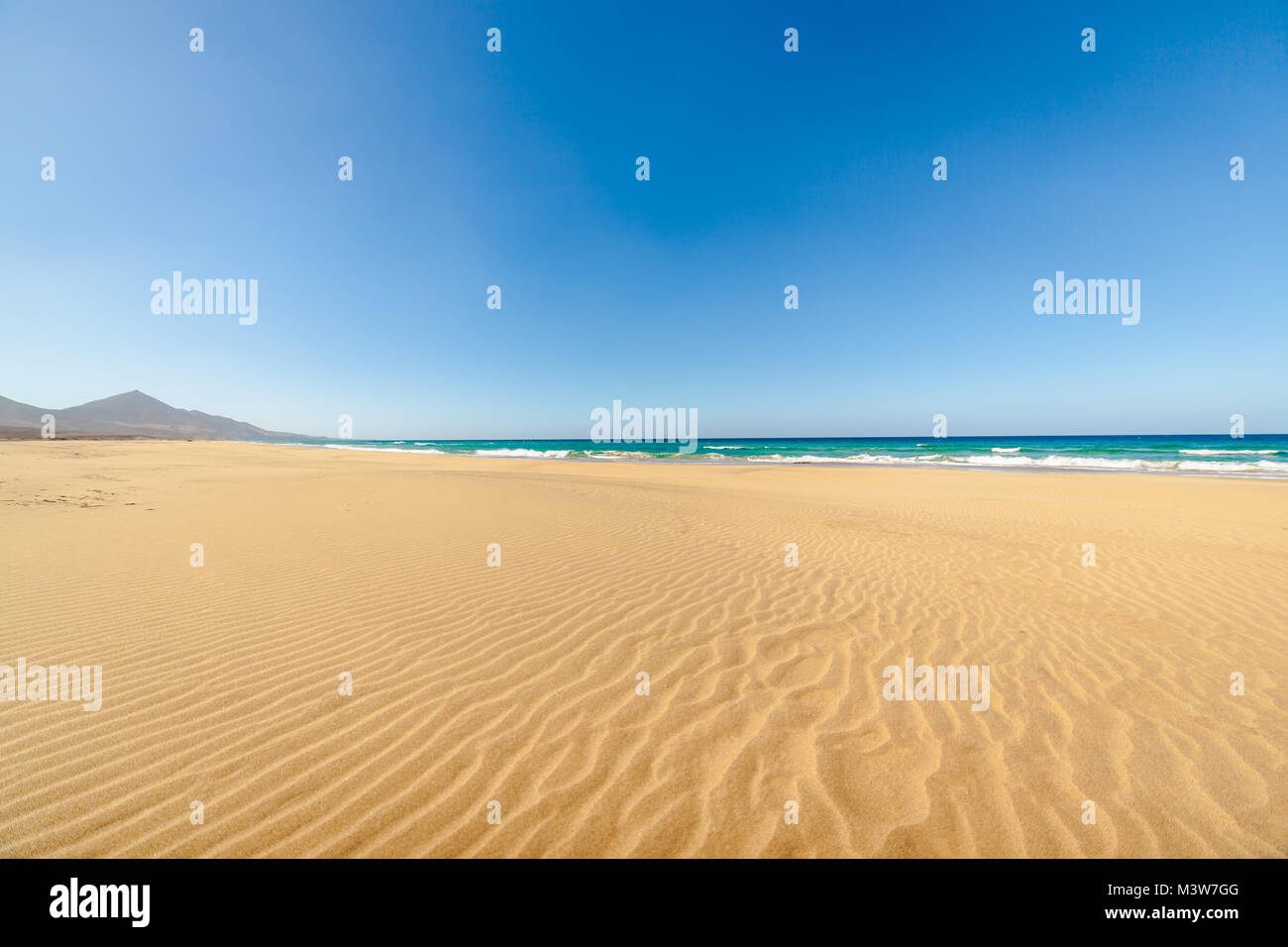 Cofete beach, Fuerteventura, Canary Islands, Spain. Amazing Cofete beach with endless horizon. Volcanic hills in the background and Atlantic Ocean. Stock Photo
