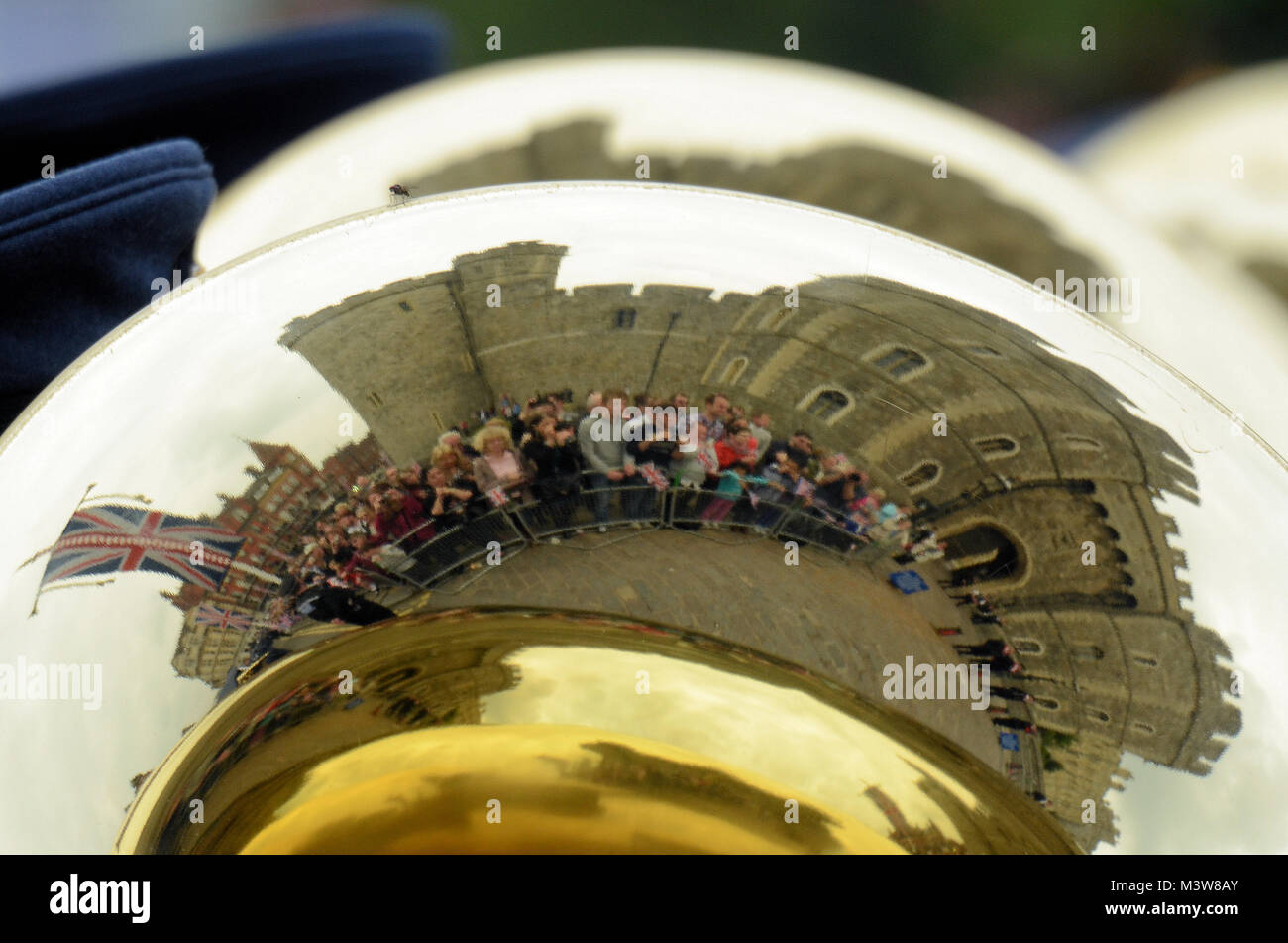 Windsor Castle and people reflected in a brass instrument of a marching band celebrating Queen Elizabeth's Diamond Jubilee Stock Photo