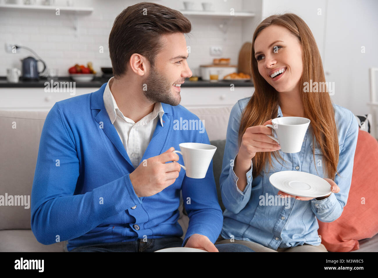 Young couple together at home weekend drinking coffee talking Stock ...