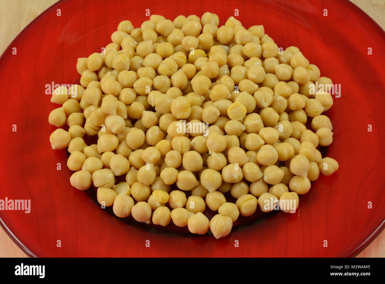 Canned garbanzo beans or chickpeas rinsed and drained and poured out on