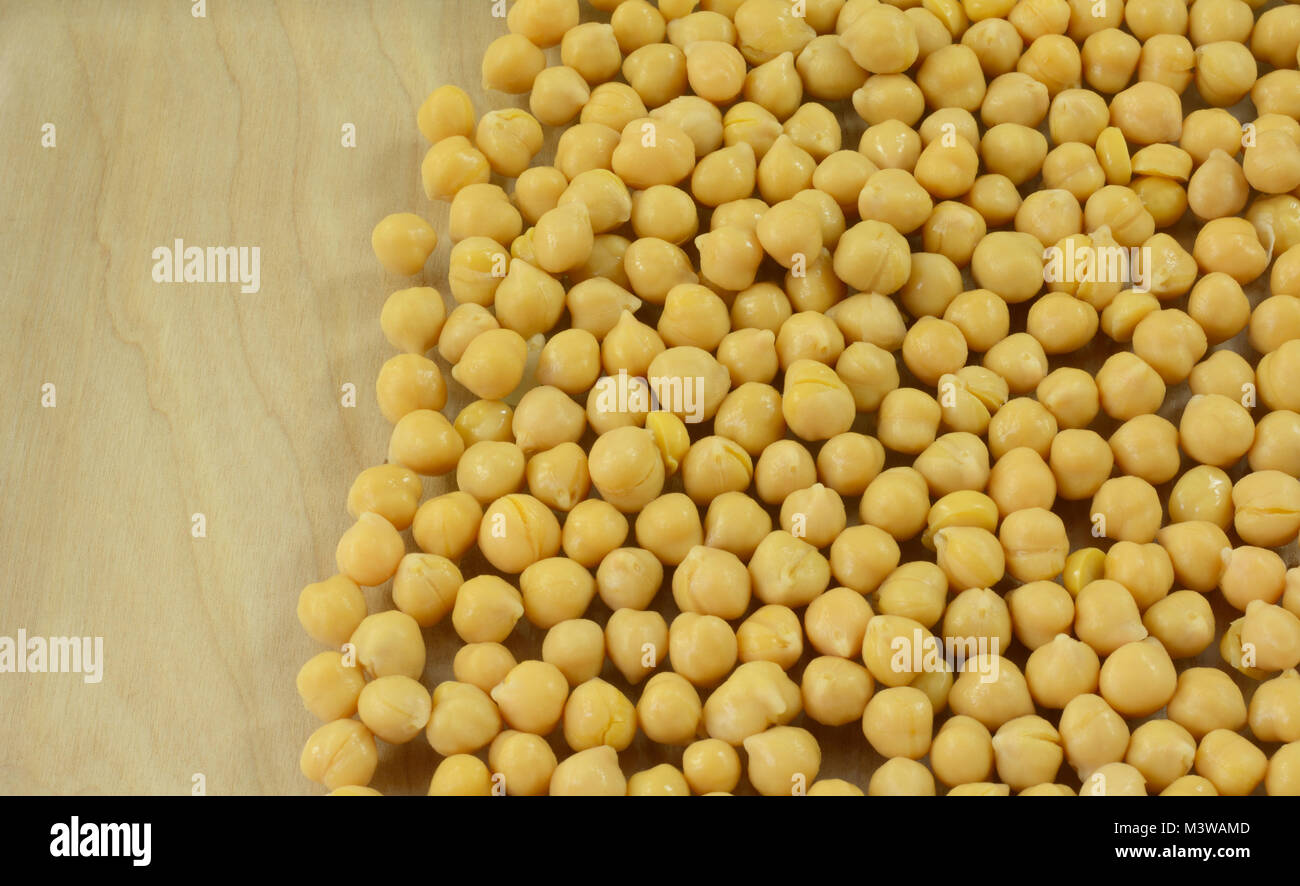 Close up of canned garbanzo beans vegetable with wood background Stock