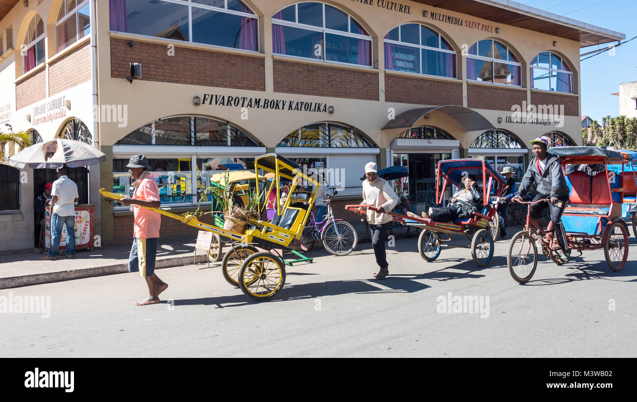 Rickshaw Drivers Pulling Passengers, Antsirabe, Madagascar Stock Photo