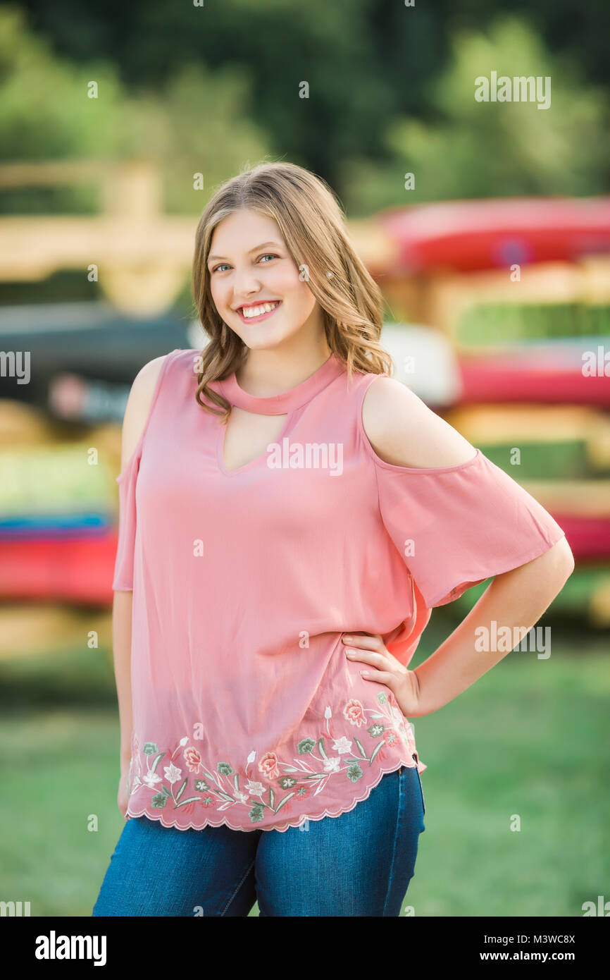 High school senior girl portraits outside during summertime. One person. Beautiful brunette teenage female. Stock Photo