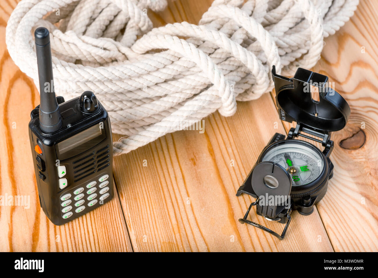 rope and navigation equipment for a complex and dangerous hike into the mountains,on a wooden background Stock Photo