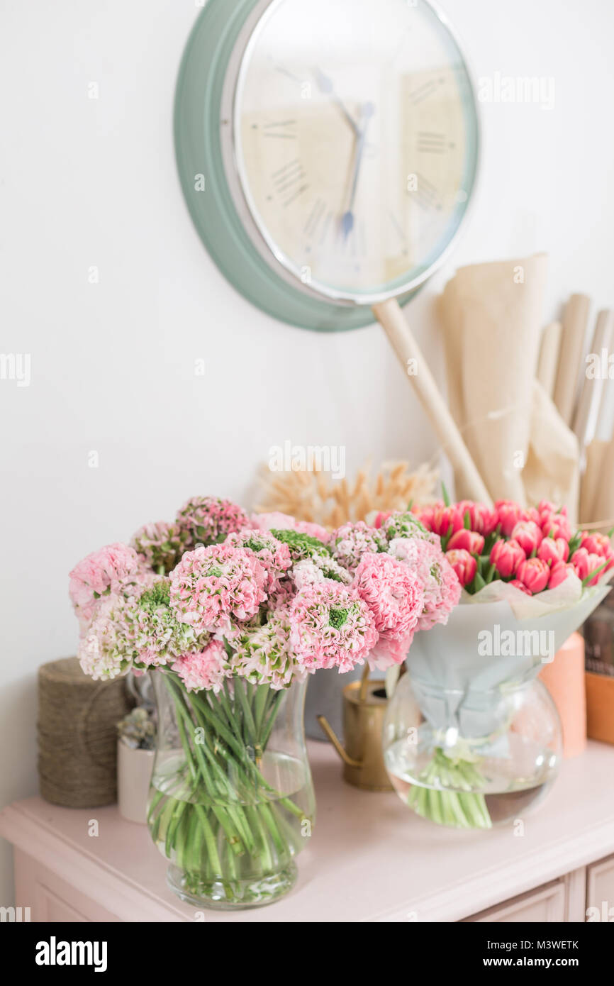 Persian buttercup. lace with many petals. Bunch pale pink ranunculus flowers light background. Wallpaper Stock Photo