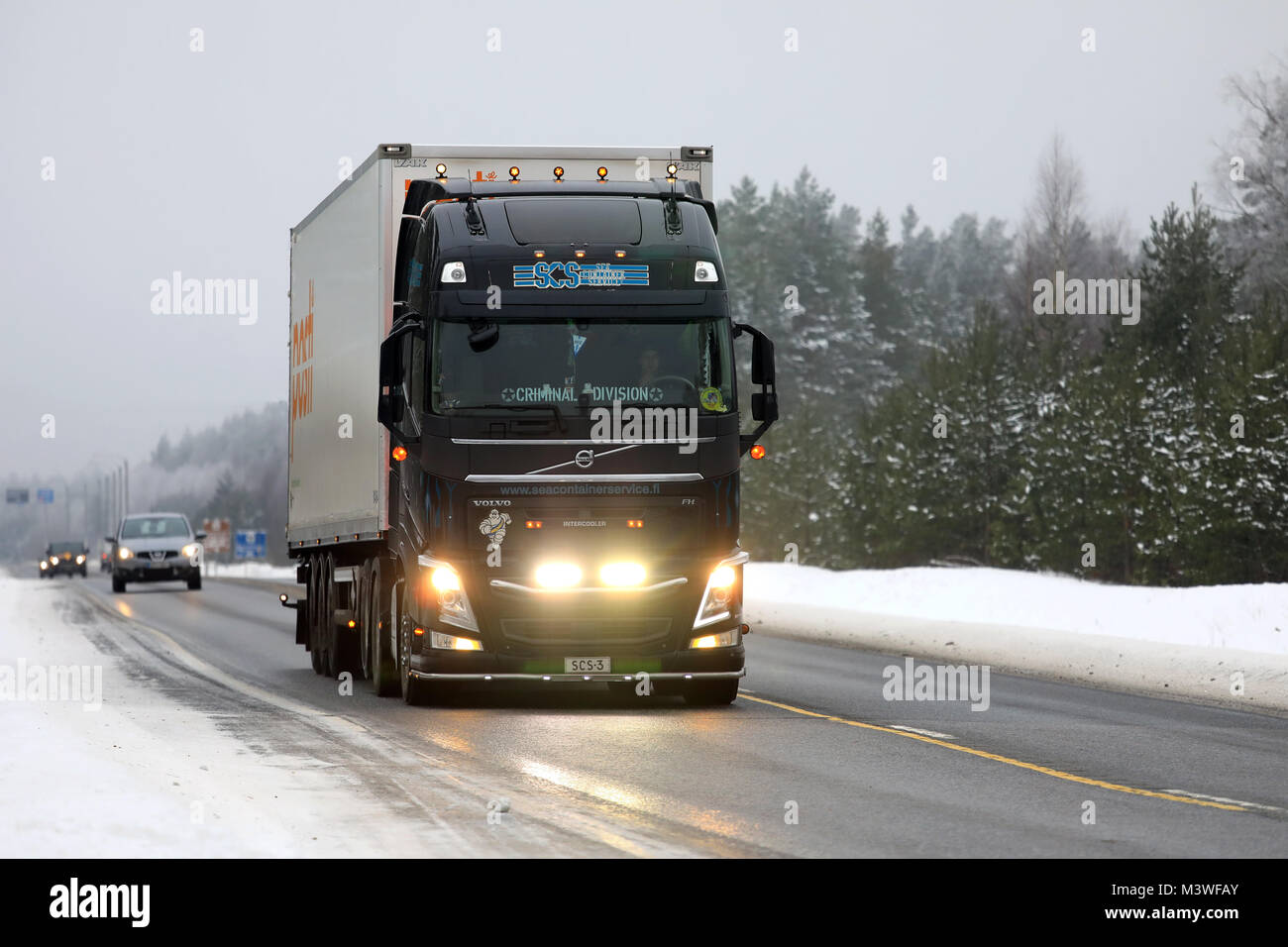 RAASEPORI, FINLAND - FEBRUARY 9, 2018: Beautifully customized Volvo FH truck of SCS for Posti Group transports lights up the wintery highway in South  Stock Photo