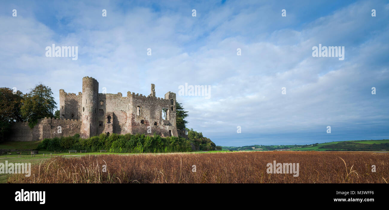 Panoramic view of Laugharne Castle across marshes Laugharne Carmarthenshire  Wales Stock Photo