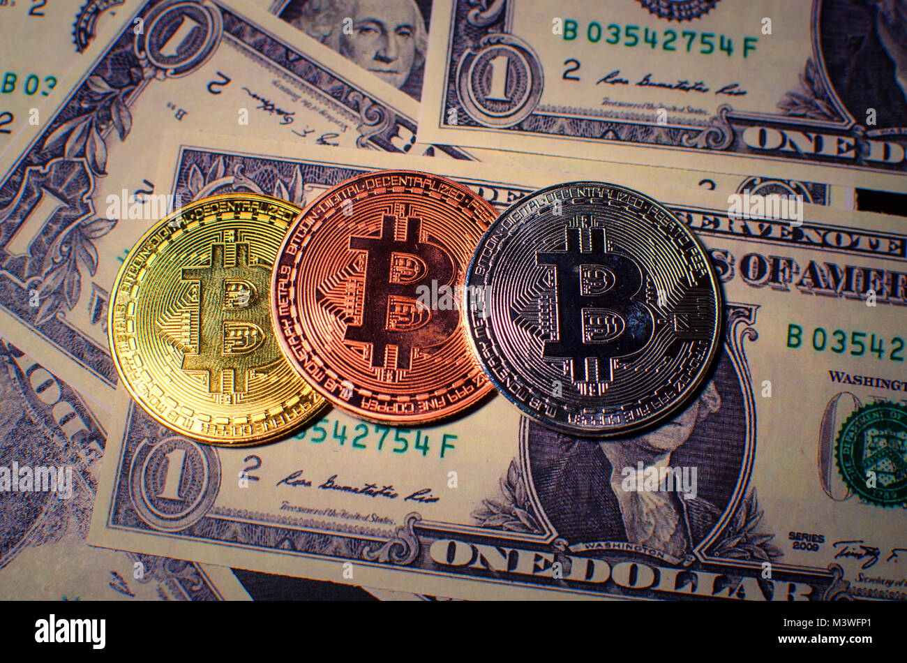 Gold, silver and Bronze Bitcoin coin and dollar Stock Photo