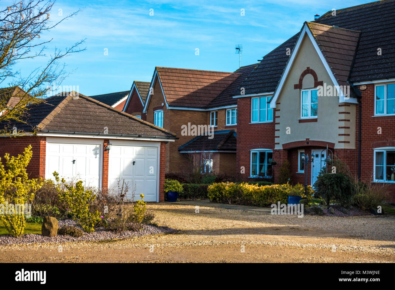 Modern brick built detached houses, with a double garage building at