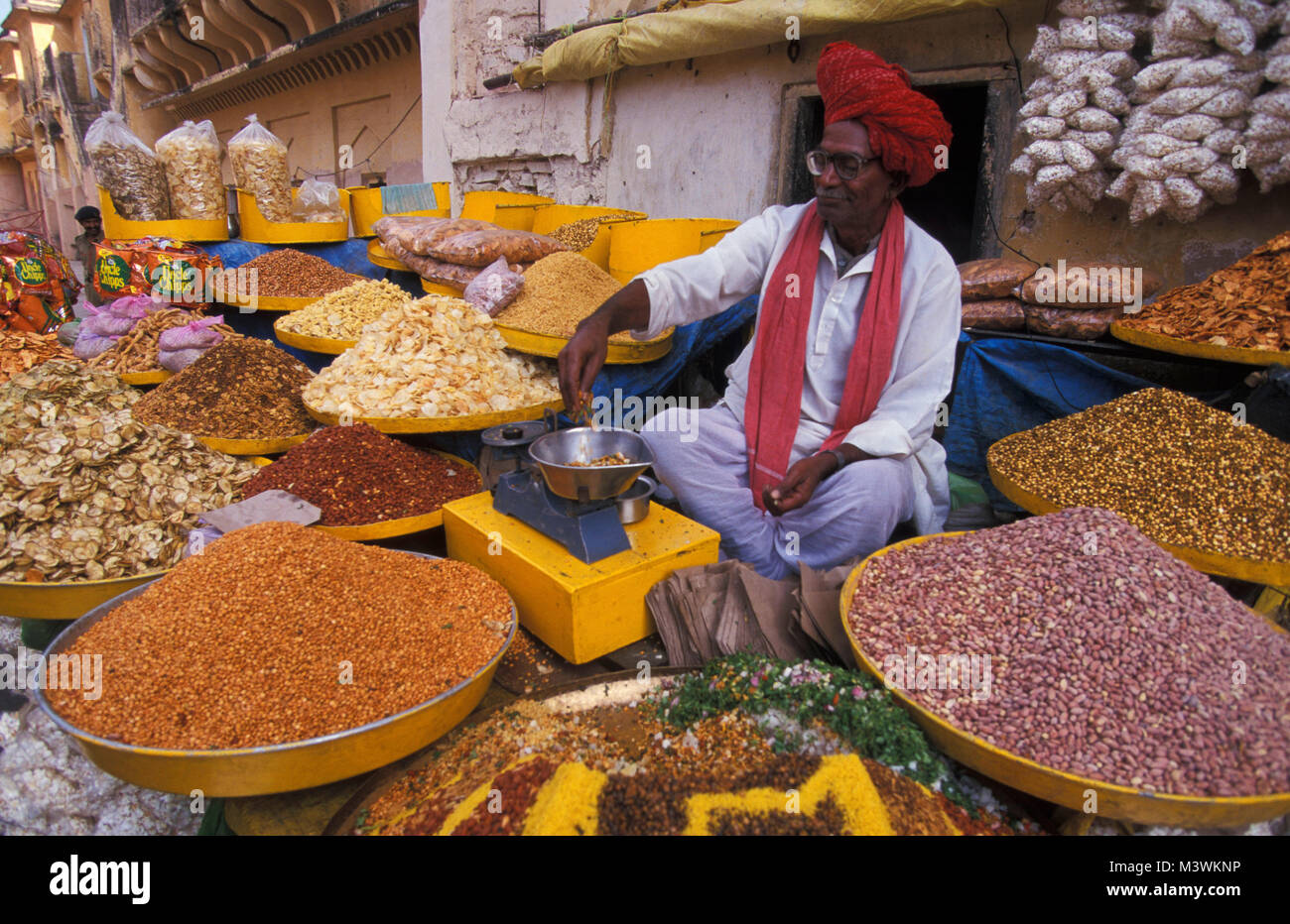 India. Rajasthan. Jaipur. Indian man selling spices on the street near palace. Stock Photo