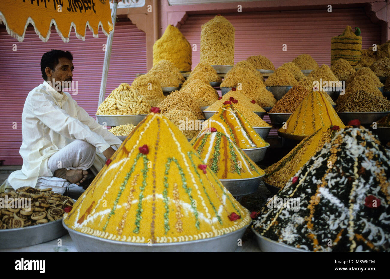 India. Jaipur. Rajasthan. Man selling spices and snacks near palace