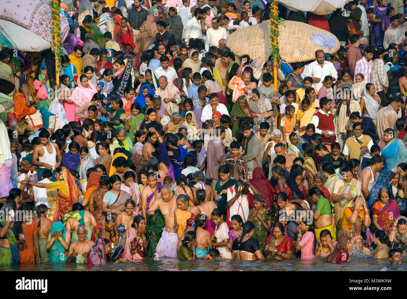 India. Varanasi (Benares). The ghats. Hindu pilgrims bathing and ...