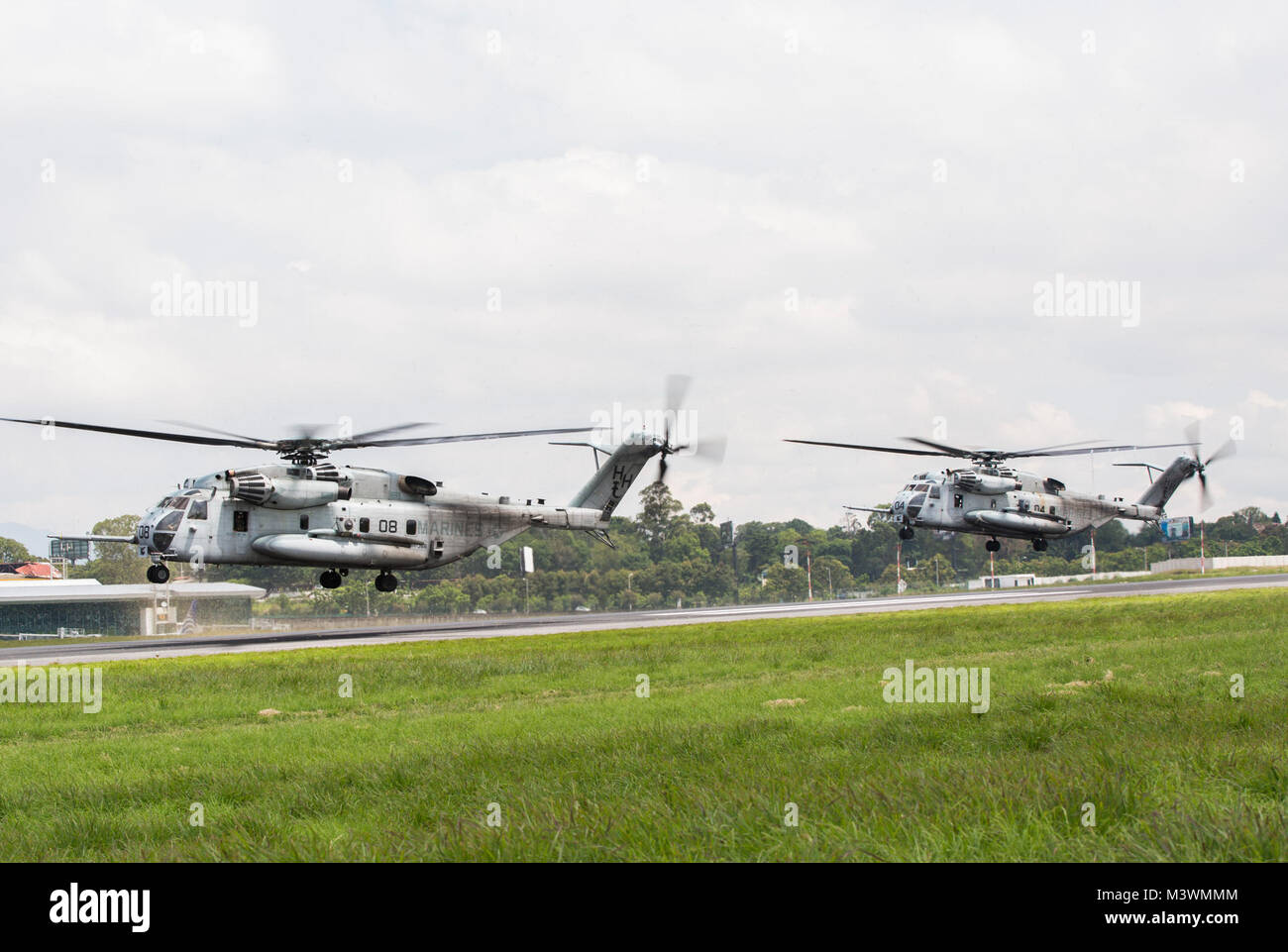Two U.S. Marine CH-53E Super Stallion helicopters with the Aviation Combat Element, Special Purpose Marine Air-Ground Task Force - Southern Command, take off from La Aurora International Airport in Guatemala City, Guatemala, Aug. 1, 2017. The ACE will be operating in Guatemala during the month of August to test the unit’s ability to operate away from their primary base and better support the other elements of the task force. The Marines and sailors of SPMAGTF-SC are deployed to Central America to conduct security cooperation training and engineering projects with their counterparts in several  Stock Photo