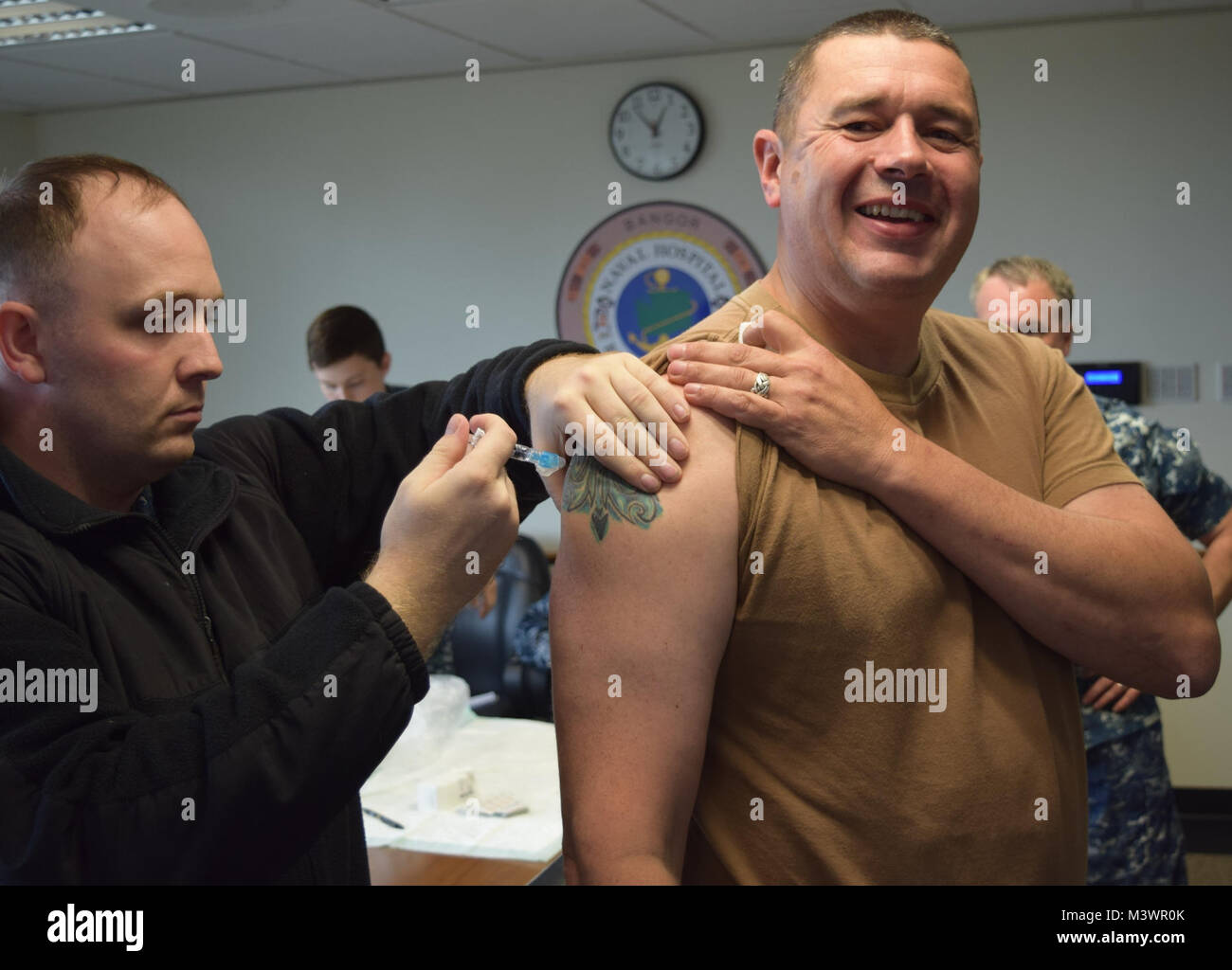 Vaccinated with a grin...Naval Hospital Bremerton Command Master Chief James Reynolds receives his influenza vaccination as Naval Hospital Bremerton's Preventive Medicine prepares to provide similar services to shore-based personnel assigned to all installation commands and tenant commands throughout Command Navy Region Northwest in a mock pandemic exercise - PANDEMIC-17 - a 2-day region wide exercise on Nov. 1-2, 2017 (official Navy photo by Douglas H Stutz, Naval Hospital Bremerton Public Affairs). 170907-N-HU933-035 by Naval Base Kitsap (NBK) Stock Photo