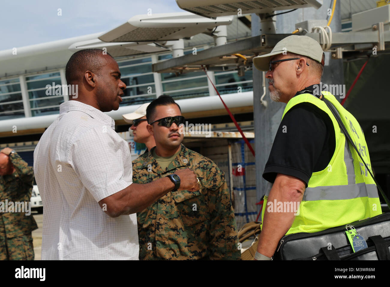 U.S. service members with Joint Task Force - Leeward Islands speak with a Federal Aviation Administration airport inspector at Princess Juliana International Airport in Saint Maarten, Sept. 15, 2017. At the request of partner nations, JTF-LI deployed aircraft and service members to areas in the eastern Caribbean Sea affected by Hurricane Irma. The joint task force is a U.S. military unit composed of Marines, Soldiers, Sailors, and Airmen, and represents U.S. Southern Command’s primary response to Hurricane Irma. (U.S. Army photo by Capt. Trisha Black) 170915-A-GF676-111 by ussouthcom Stock Photo