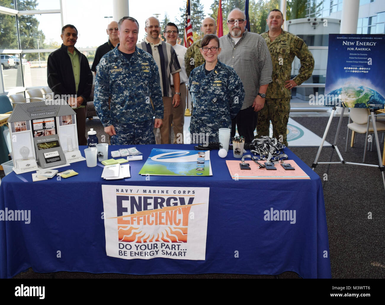 Helping to shed light on some conservational energy...Capt. Jeffrey  Bitterman, Naval Hospital Bremerton (NHB) Commanding Officer, Capt. Kristin Hodapp, acting-Executive Officer, Command Master Chief James Reynolds, Facilities Management Department members Russ Kent, Robert Mitchell, Ramon Calantas, and Naval Base Kitsap Energy Manager Paul Songe-Muller and Navy Facilities Engineering Command Energy Manager Curtis Hickle, convene at an informational table on NHB's  Quarterdeck, Oct. 24, 2017. The event provided another opportunity for NHB to continue keeping energy preservation and awareness a Stock Photo