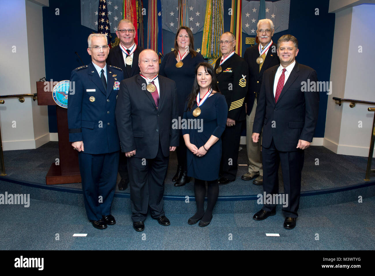 Recipients of The Spirit of Hope Award stand for a photograph with Vice Chairman of the Joint Chiefs of Staff Gen. Paul Selva, front left, and Michael Rhodes, director of administration at the Office of the Deputy Chief Management Officer, front right, after the awards presentation at the Pentagon in Arlington, Va. Oct. 26, 2017. The recipients are in front from left Kevin Ou and Jennifer Correla, and in back from left, Robert Irvine, Ann O’Connor of Trees for Troops, Retired Chief Petty Officer Jim Marshall, and Richard Stone of Special Forces Home for Christmas Fund. 171026-D-DB155-007 by Do Stock Photo