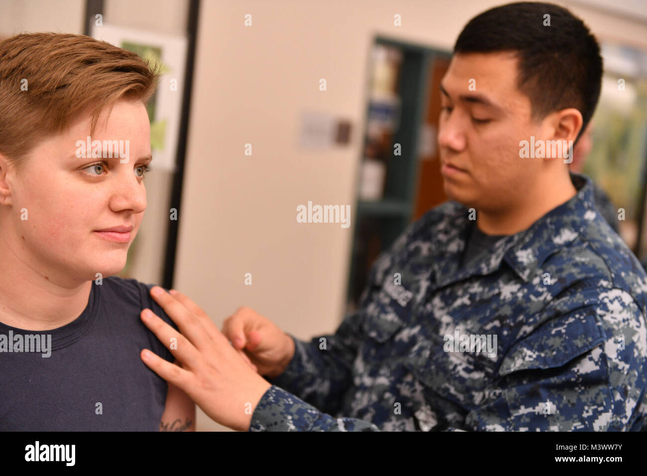 171101-N-JT254-014 SILVERDALE, Wash. (November 01, 2017) Hospital Corpsman Seaman Adrian Bermudez assigned to Naval Hospital Bremerton, administers a flu vaccine to Aviation Ordnancemen 1st Class Ashley Walicki, assigned to Naval Base Kitsap-Bangor Transient Personnel Unit.  Influenza, or 'the flu”, has the potential to adversely impact Navy force readiness and mission execution, and vaccination is mandatory for DoD uniformed personnel. (U.S. Navy photo by Mass Communication Specialist Seaman Christopher Jahnke) 171101-N-JT254-014 by Naval Base Kitsap (NBK) Stock Photo