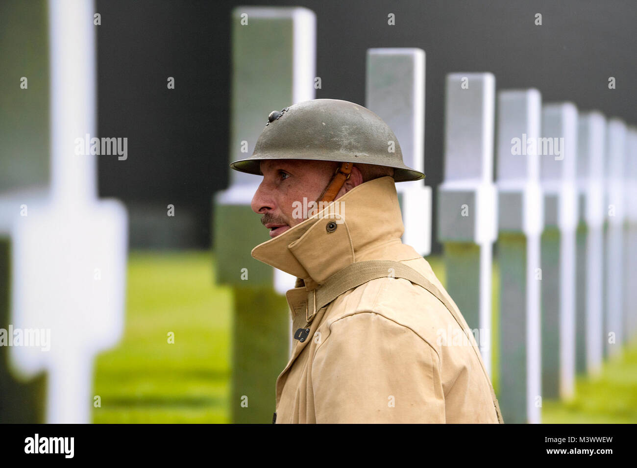 A World War I re-enactor passes by photograph on display for the  National World War I Memorial groundbreaking at Pershing Park in Washington, D.C. Nov. 9, 2017. Construction of the memorial is expected to be completed in a year. (DoD photo by EJ Hersom) 171109-D-DB155-001 by DoD News Photos Stock Photo
