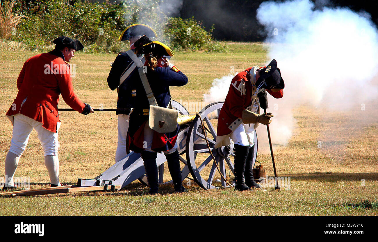 British artillerymen fire a cannon at advancing rebel troops of the American Continental Army during a re-enactment of the Battle of Camden. The battle was a humiliating defeat for Maj. Gen. Horatio Gates, a field commander for the Continental Army, and one that strengthened Great Britain's hold on the Carolinas. (U.S. Air Force photo/Rob Sexton) War Reenactment-003 by AirmanMagazine Stock Photo