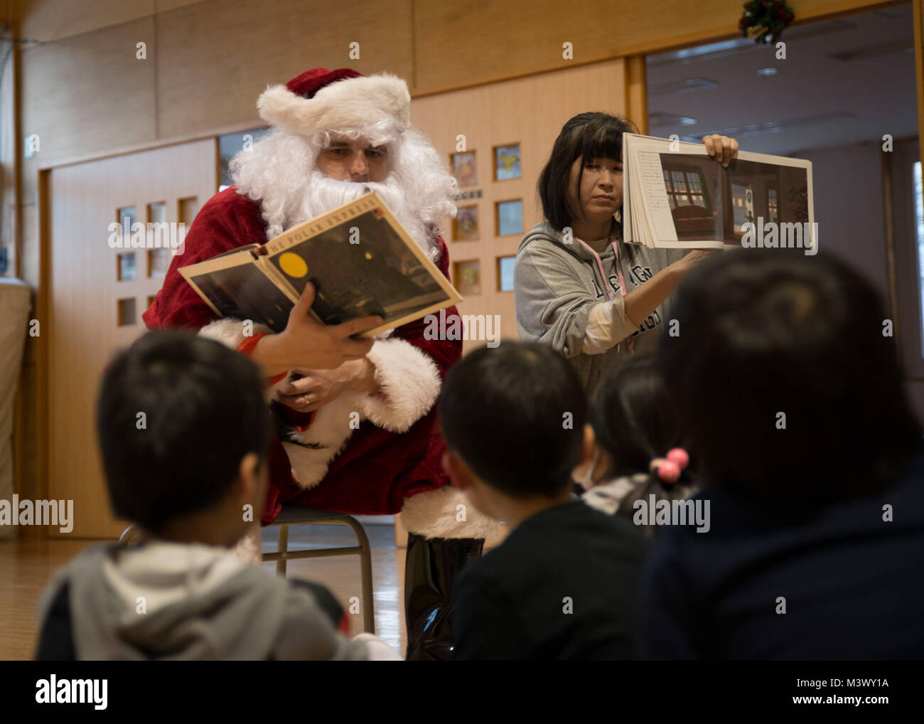 171218-N-DA275-058 MISAWA, Japan (Dec. 18, 2017) Legalman 1st Class Donald McDowell, assigned to Naval Air Facility Misawa (NAFM), visits children at the Ohzora Jido-Kan, a Japanese after school care center, dressed as Santa Claus for a special holiday themed visit. Sailors from NAFM volunteer to make bi-weekly visits to the after school care center as part of community relations efforts. (U.S. Navy photo by Mass Communication Specialist 3rd Class Samuel Bacon/Released) 171218-N-DA275-058 by Photograph Curator Stock Photo
