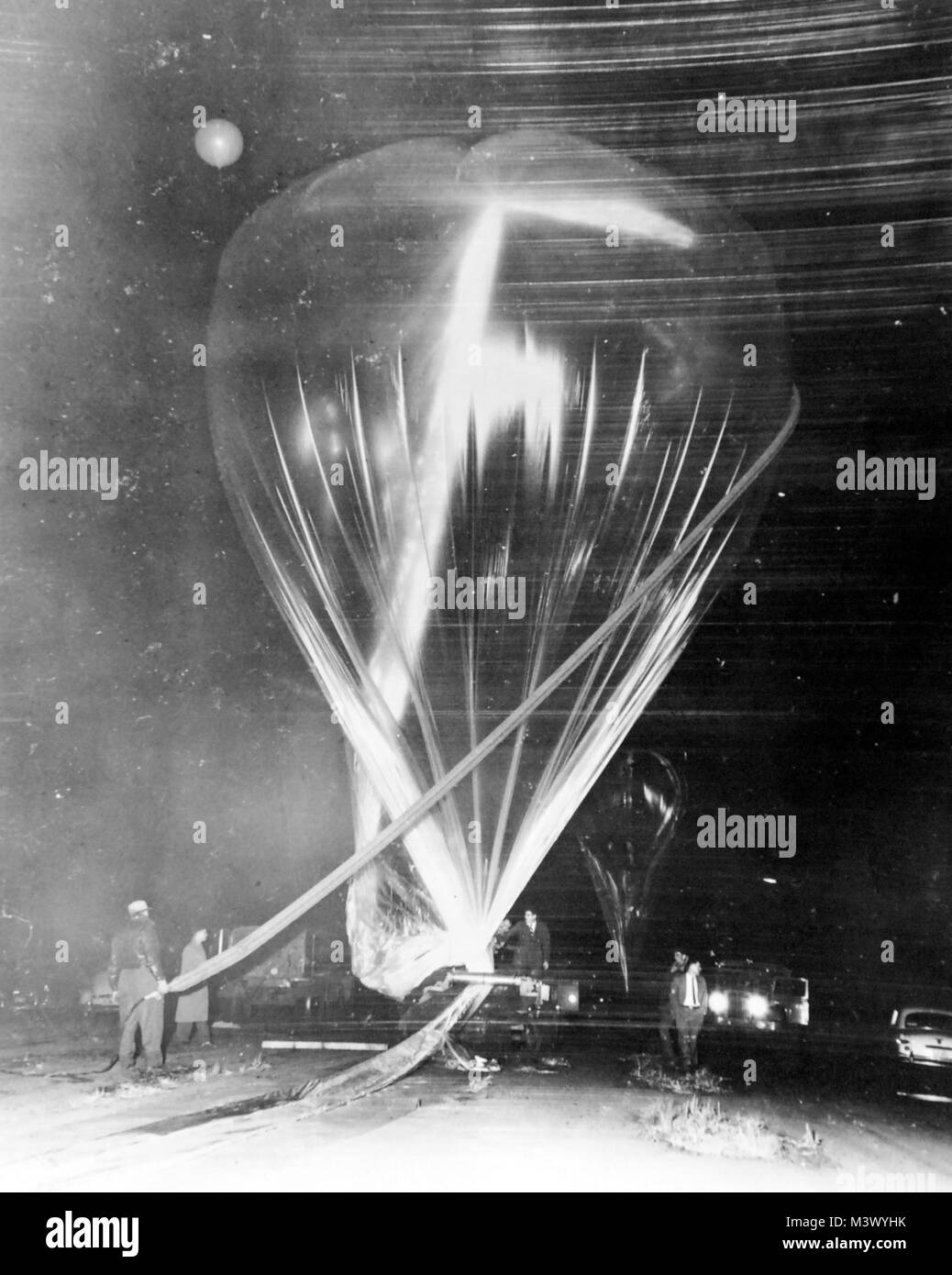 80-G-680470:  Operation “Sky Hook” one of the stages in the inflation and launching of the General Mills “Super Sky Hook” balloon.  Photograph received May 1954.  Official U.S. Navy Photograph, now in the collections of the National Archives.  (2018/01/17). 80-G-680470 25877128368 o Stock Photo
