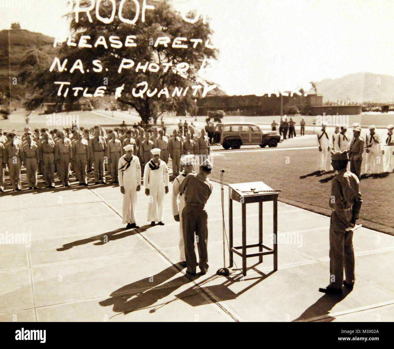 80-G-419189:  Pearl Harbor, Territory of Hawaii, May 1943.  Captain Wallace M. Dillon presents Purple Heart at Naval Air Station, Kaneohe Bay.  Shown:   S1 Fred William Jordan receives award.  Also awarded during ceremony were PRTR3 Leroy G. Maltby and AM2 Wayne Alford Johnson.  Men were wounded during the Japanese raid on December 7, 1941.  Official U.S. Navy Photograph, now in the collections of the National Archives.  (2018/01/24). 80-G-419189 38979975545 o Stock Photo