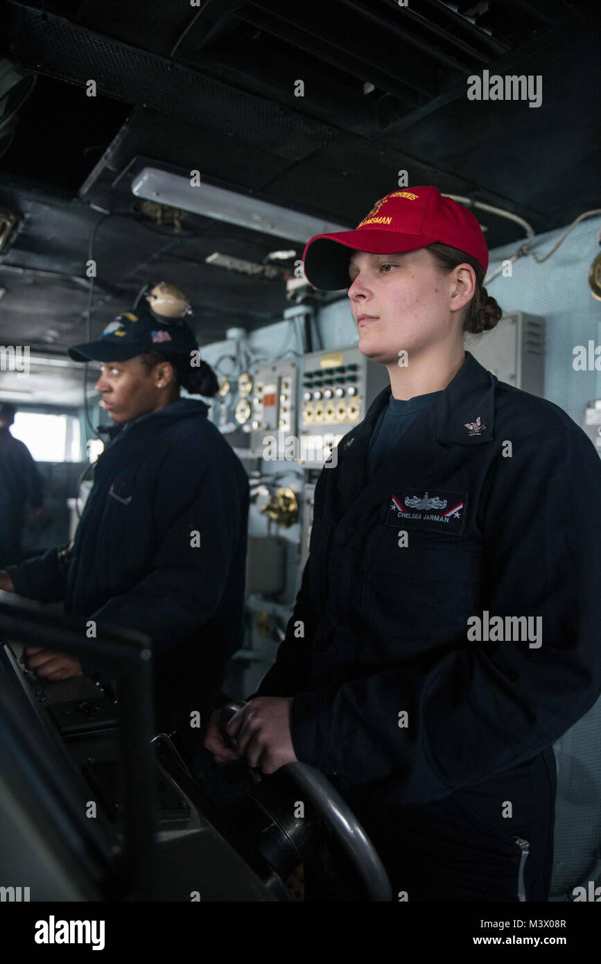 180129-N-EC099-073   STRAIT OF JUAN DE FUCA (Jan. 29, 2018) Operations Specialist 2nd Class Chelsea Jarman, from Boydton, Virginia, steers USS John C. Stennis (CVN 74) as Master Helmsman as the ship returns to Naval Base Kitsap – Bremerton. John C. Stennis is returning to homeport after the completion of a two-week underway where the ship’s crew conducted training to prepare for its next scheduled deployment. (U.S. Navy photo by Mass Communication Specialist 3rd Class Charles D. Gaddis IV/Released) 180129-N-EC099-073 by Naval Base Kitsap (NBK) Stock Photo