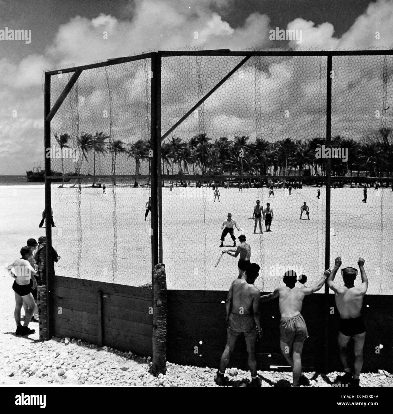 80-G-412960:  Mog-Mog Island.  Enlisted men enjoy a game of baseball.  Photograph by Steichen Photographic Unit, TR-15757.  Photograph received April 7, 1950.      Official U.S. Navy Photograph, now in the collections of the National Archives.  (2018/01/31). 80-G-412960 40008539151 o Stock Photo